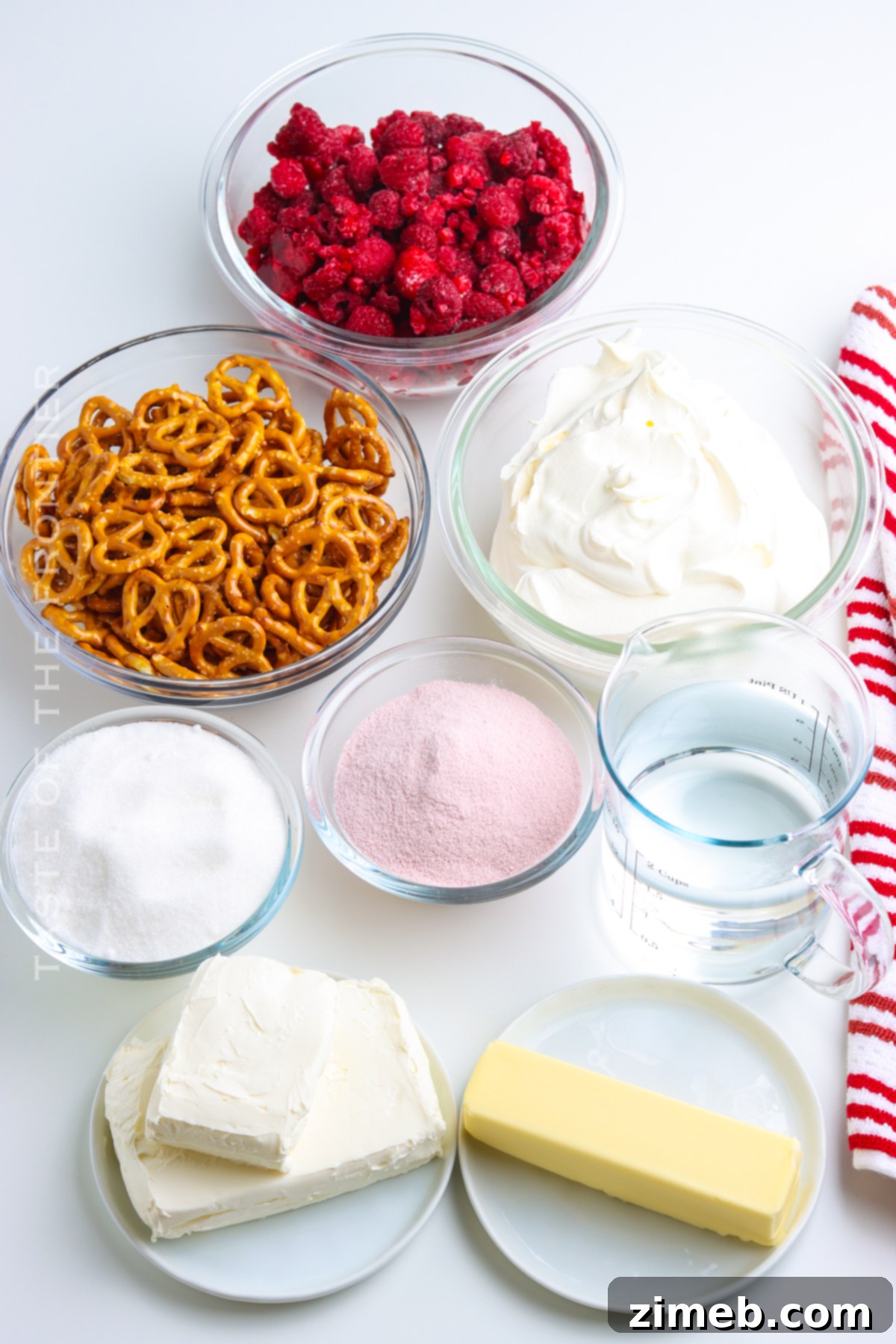 Salty Sweet Raspberry Dream 4 Ingredients for Raspberry Pretzel Salad - Fresh raspberries, jello, cream cheese, and pretzels laid out.