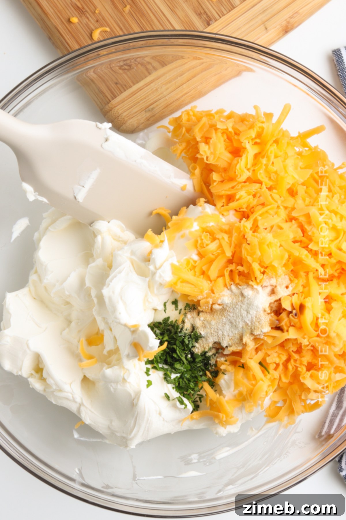Mixing the creamy and flavorful filling for a homemade cheese ball