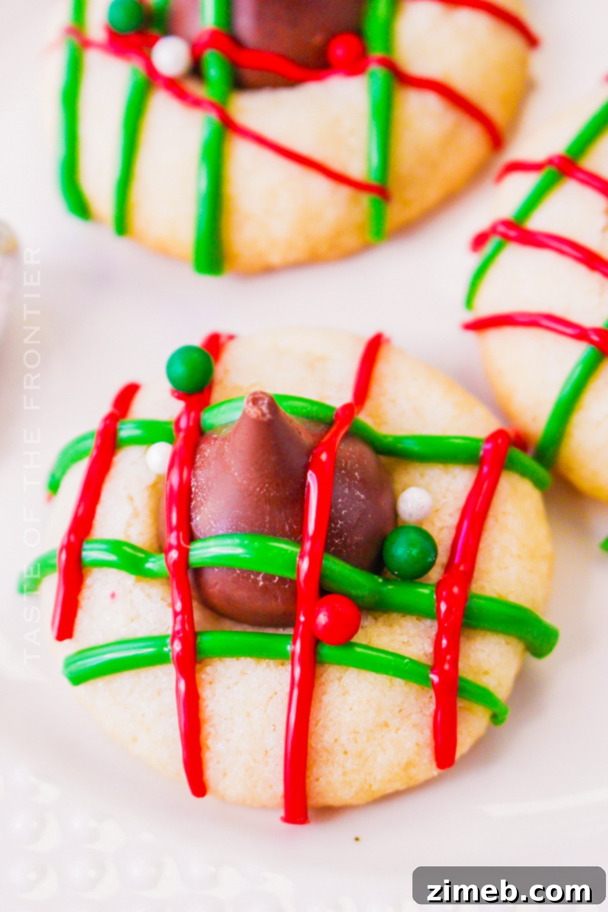 Buttery Christmas Shortbread 3 Close-up of festive shortbread kiss cookies with chocolate drizzle, ready for holiday celebrations.