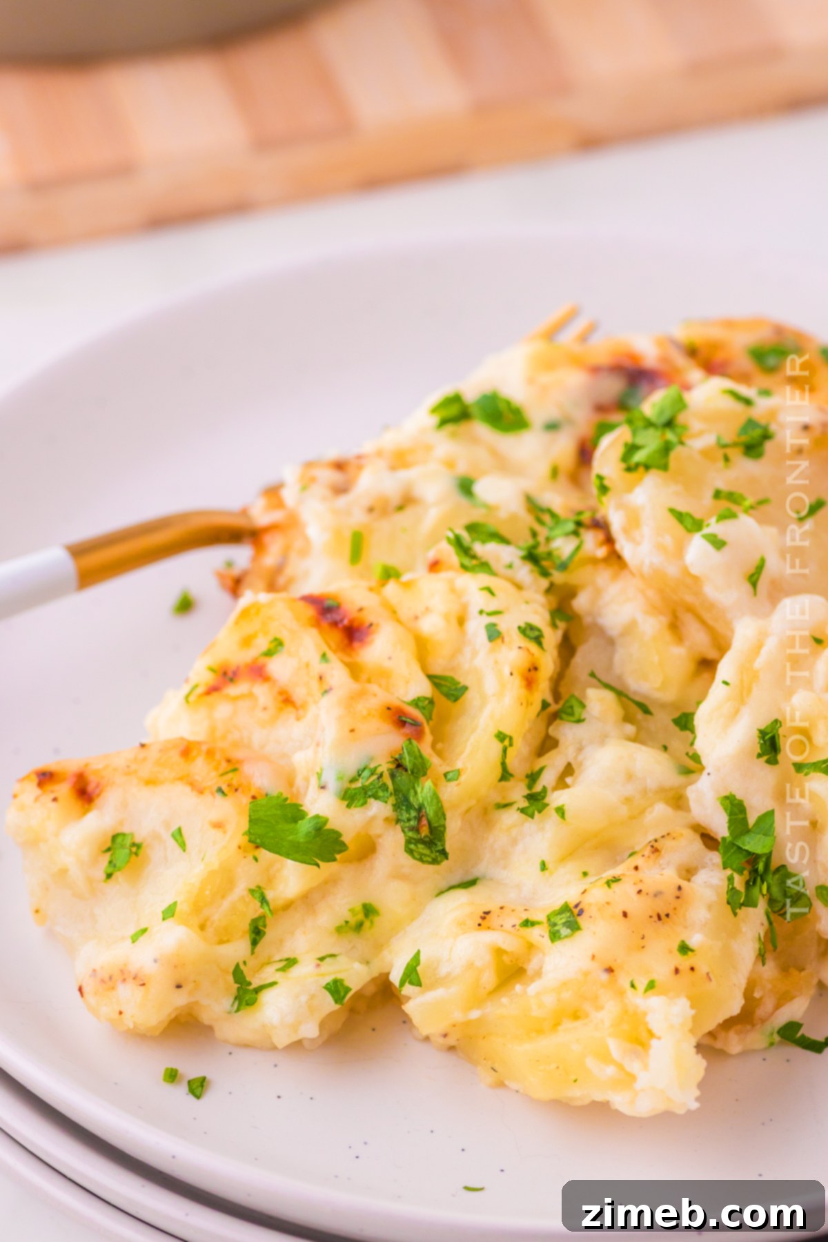 Creamy Cheesy Potato Layers 21 Freshly baked Homemade Potatoes Au Gratin in a serving dish.