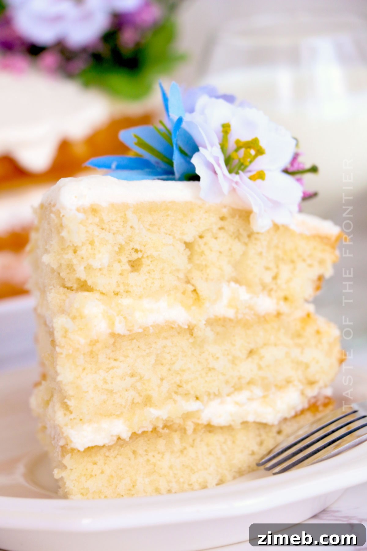 Petal Perfect Cake 9 Elegant white cake adorned with delicate fresh flowers