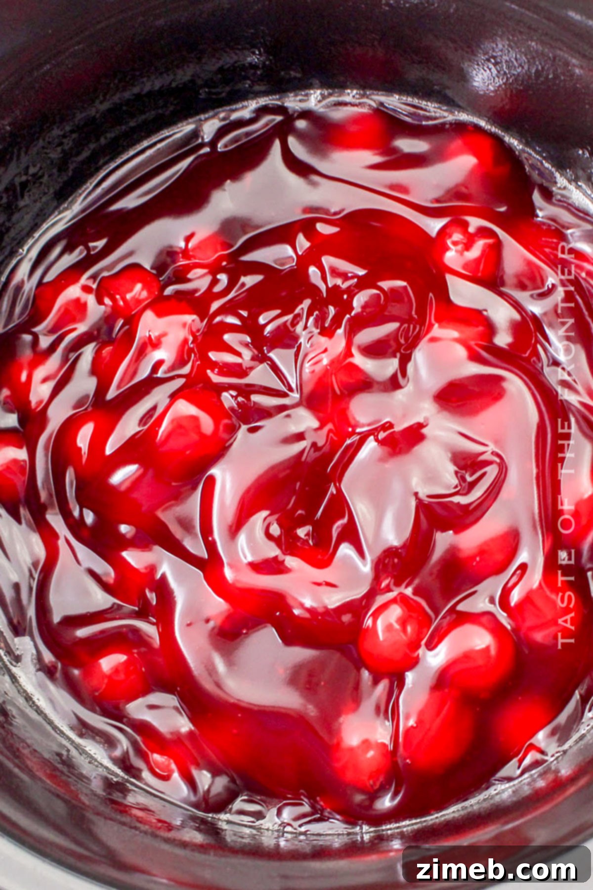 Effortless Cherry Dump Cake 5 Adding cherry pie filling to the slow cooker