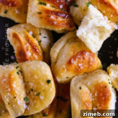 A basket full of golden Salted Honey Parker House Rolls, perfect for any meal.