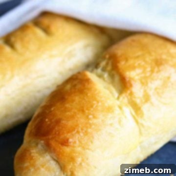 Freshly baked Homemade French Bread with a golden crust on a cooling rack.