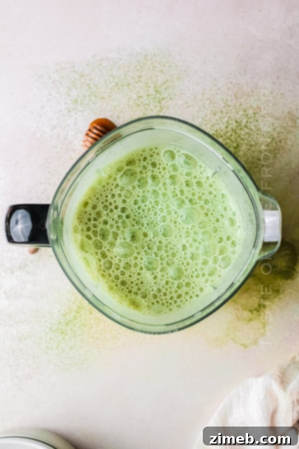 Matcha Refresher 7 Hands holding a glass of freshly made matcha shake with sprinkles