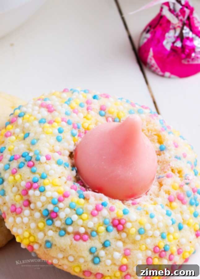 A plate of strawberry Hershey kiss cookies ready to be served