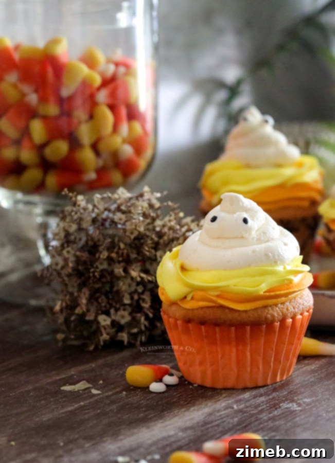Spooky Ghost Cupcakes 14 Halloween party cupcakes decorated as ghosts, ready for serving.