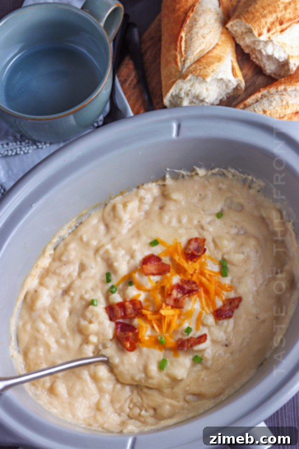 Baked potato soup in a crockpot, showing a close-up of the creamy texture