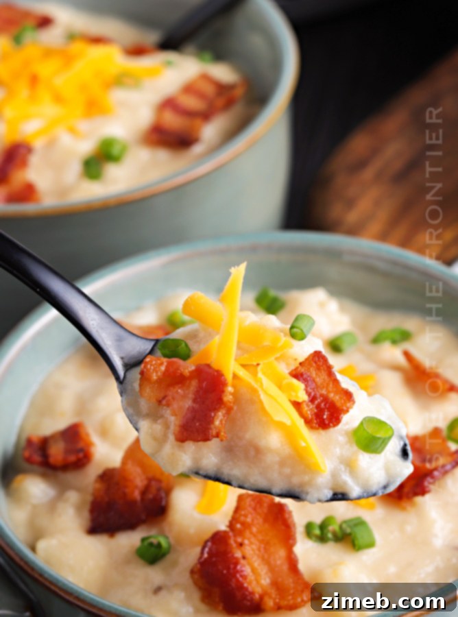 Easy Crockpot Potato Soup with a creamy texture, topped with fresh chives and melted cheese