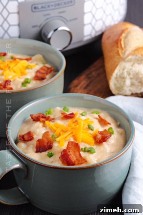 Slow Cooker Potato Soup served in a rustic bowl, garnished with bacon and chives