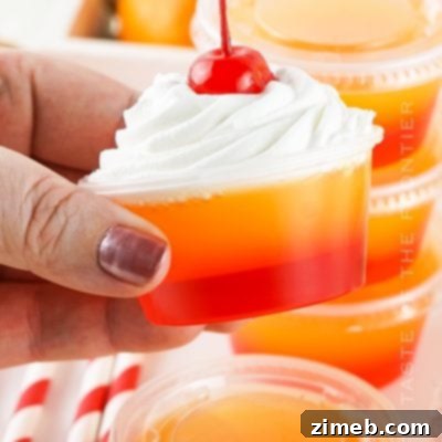 Layered orange and red Tequila Sunrise jello shots.
