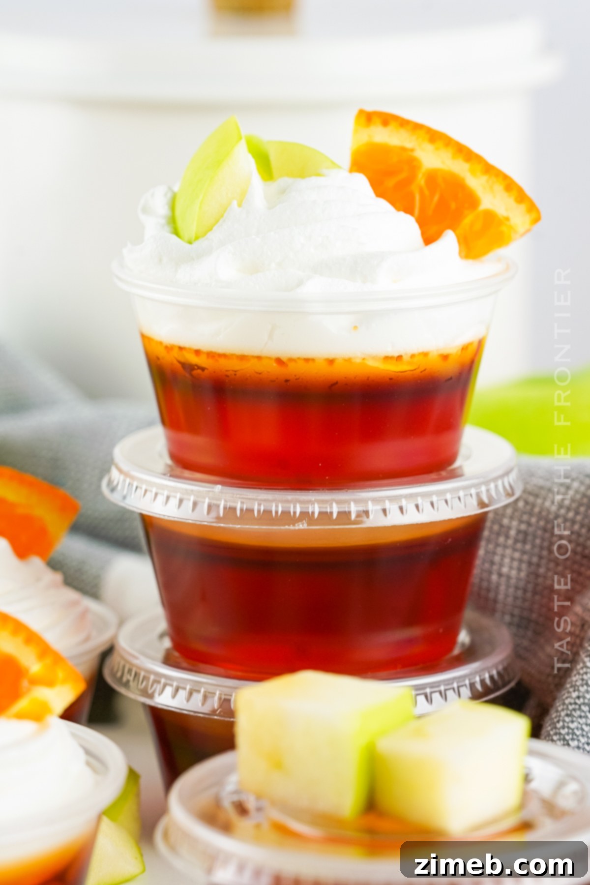 Close-up of a glass of traditional sangria with fruit next to Sangria Jello Shots.