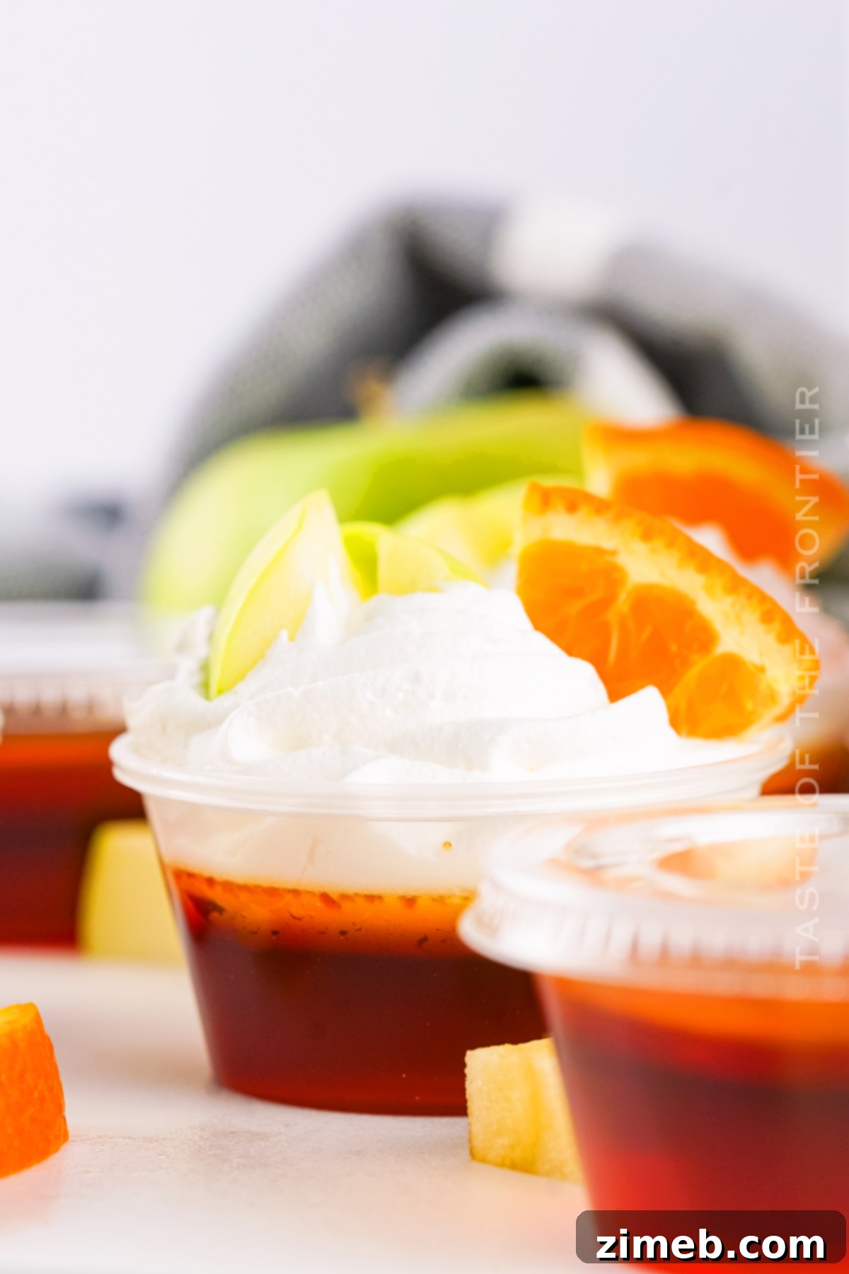 Close-up of sparkling wine jello shots with a rich red color, ready for serving.