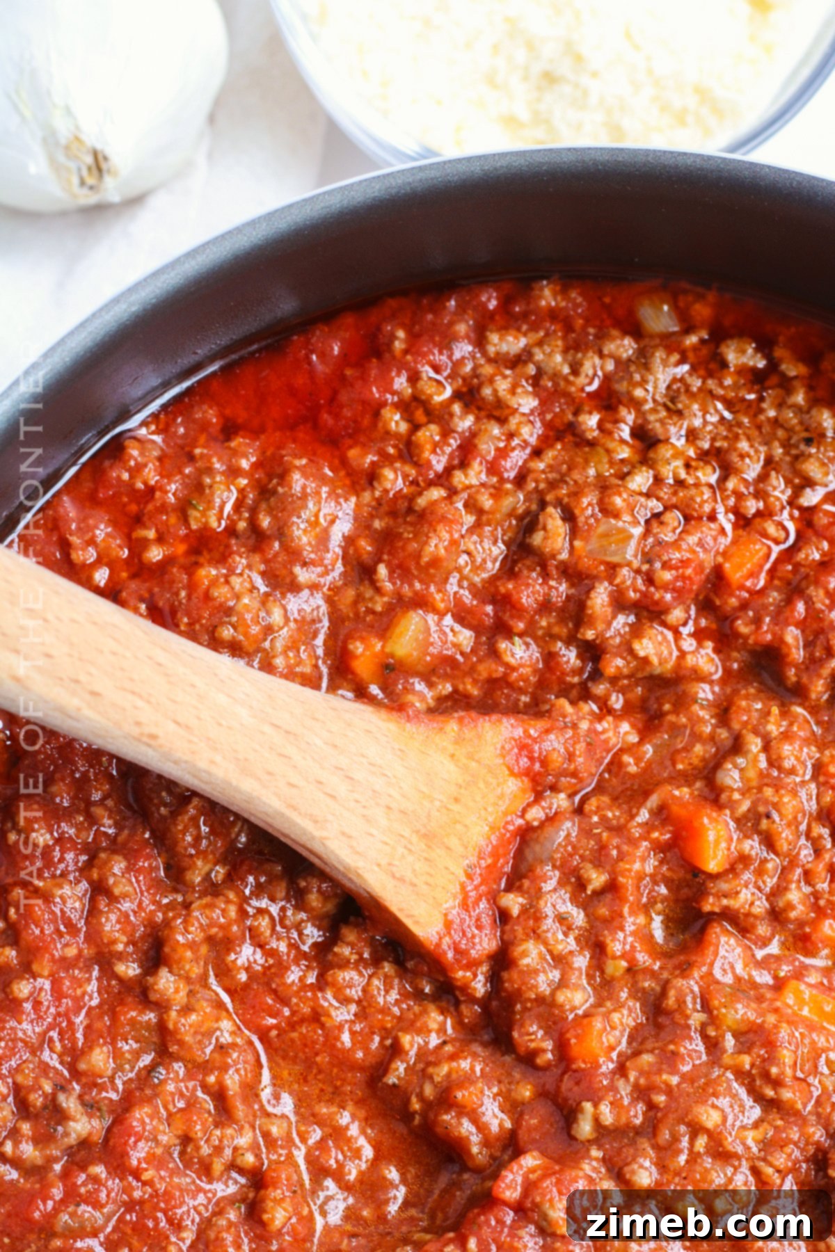 Effortless Weeknight Bolognese 19 Homemade pasta sauce with beef, simmering in a pot.
