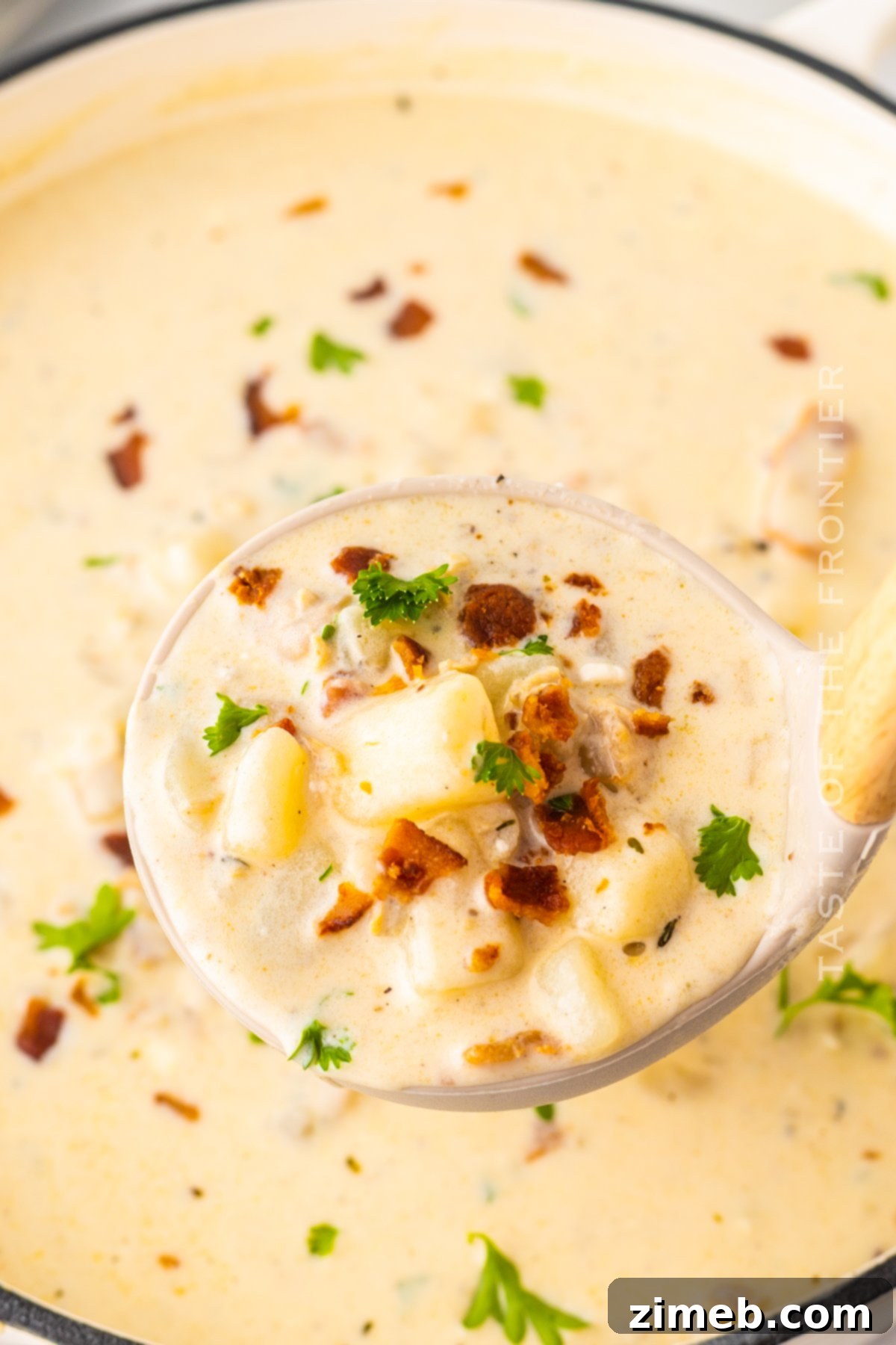 Boston-Style Clam Chowder 2 Classic New England Clam Chowder in a rustic bowl, garnished with fresh herbs and served with crusty bread.